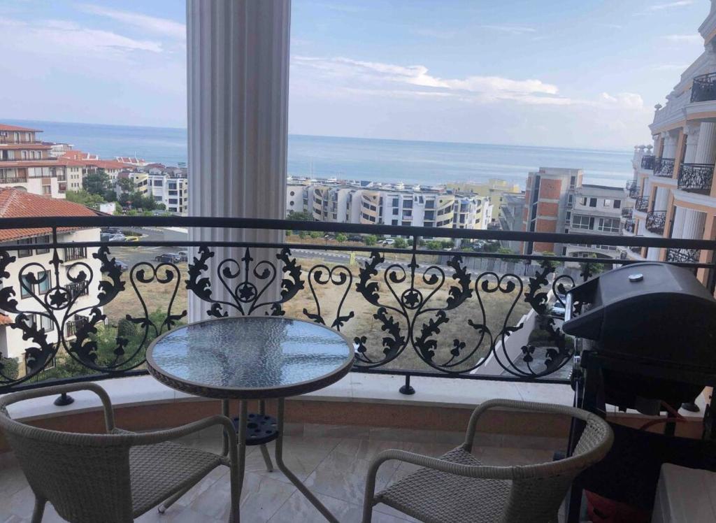 a balcony with a table and chairs and a view at Amazing apartment facing the sea in Burgas City