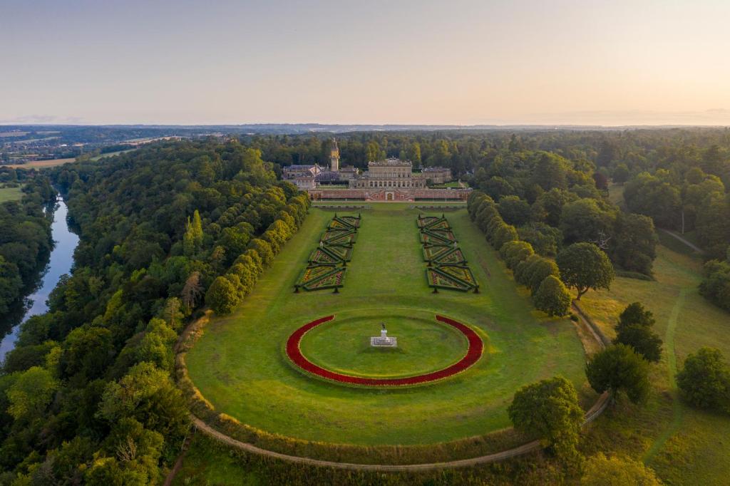 an aerial view of a park with a building in the middle at Cliveden House - an Iconic Luxury Hotel in Taplow