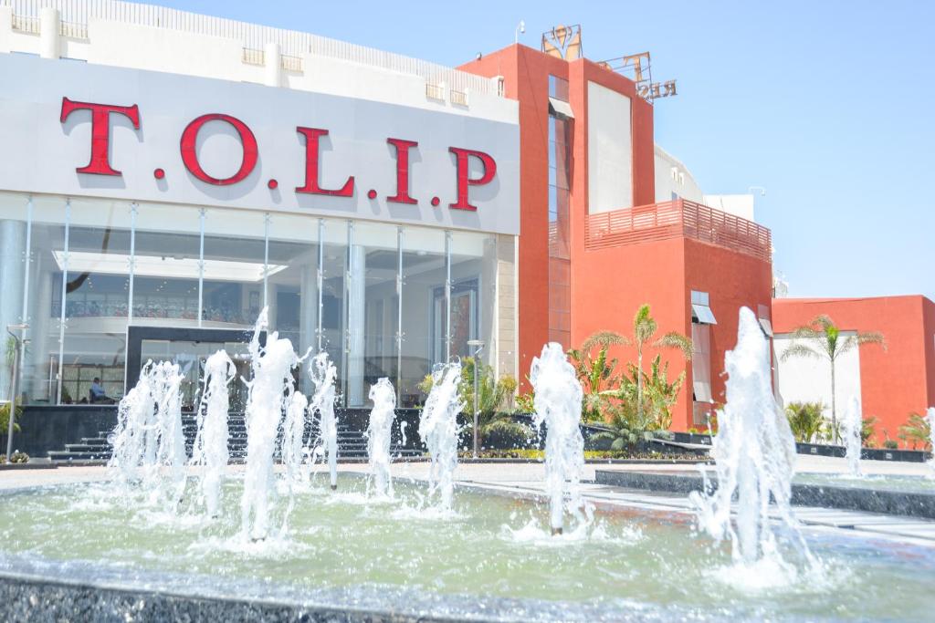 a fountain in front of a tulsip building at Tolip El Narges in Cairo