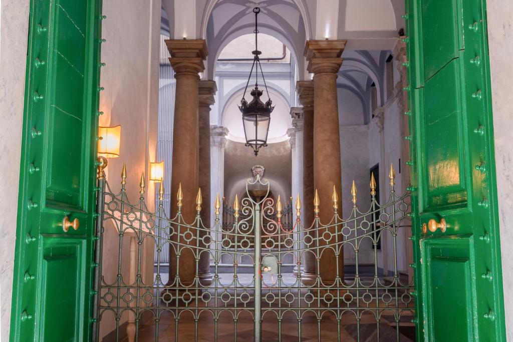 a gate in a building with a statue behind it at L'angolo di Luccoli in Genoa