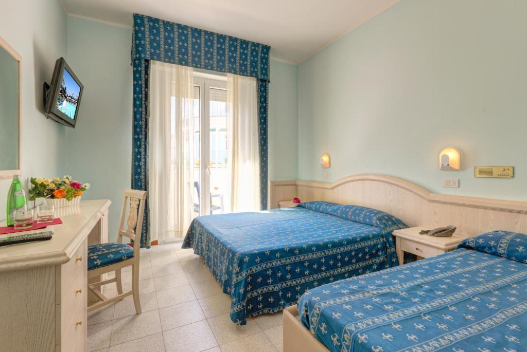 Postel nebo postele na pokoji v ubytování Hotel Splendid Mare