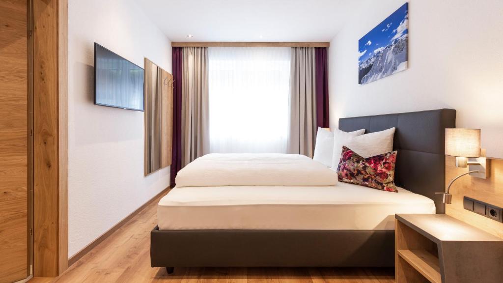 Postel nebo postele na pokoji v ubytování Aparthotel Lerch