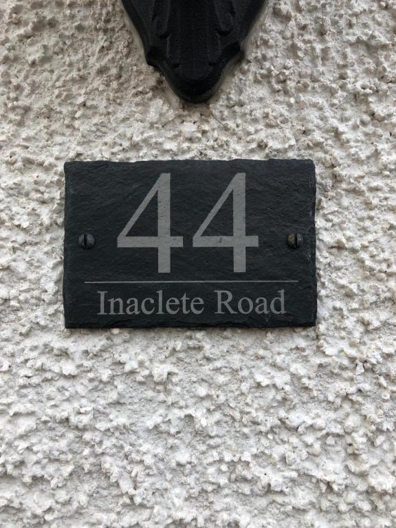 a sign on the side of a building at 44 Inaclete Road in Stornoway