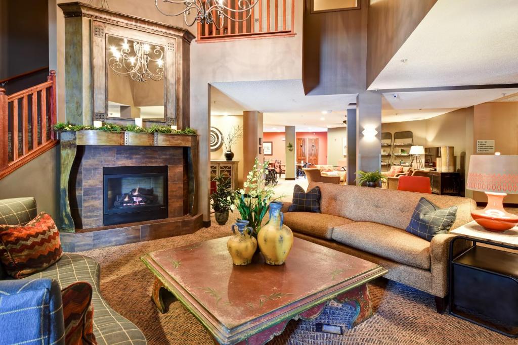 a living room with a couch and a fireplace at GrandStay Hotel & Suites La Crosse in La Crosse