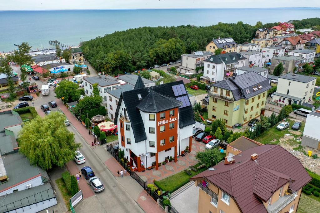 an aerial view of a small town with a street at Willalux in Mielno