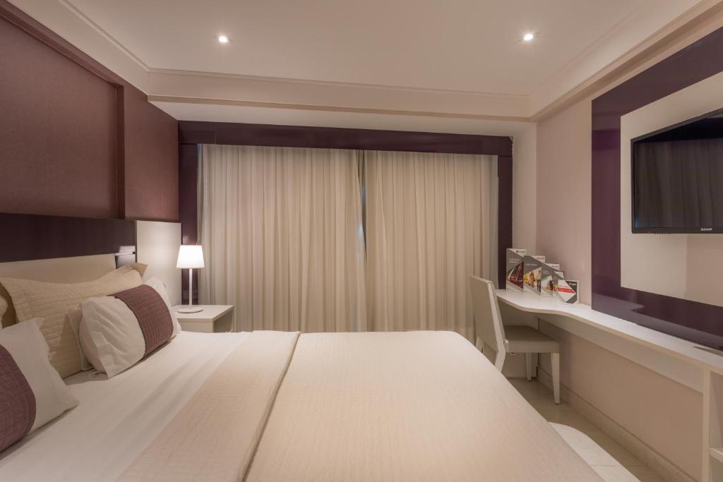 Cama ou camas em um quarto em Nord Luxxor Sapucaia