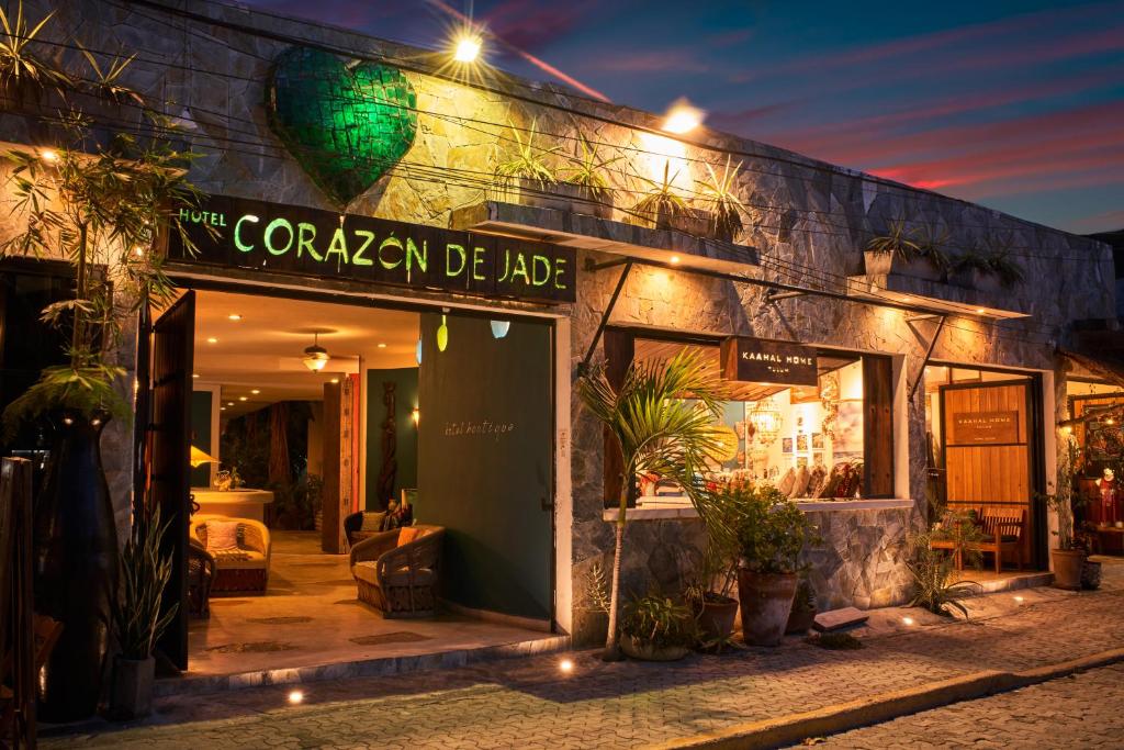 a building with a sign for a cafe at night at Corazon De Jade Tulum in Tulum