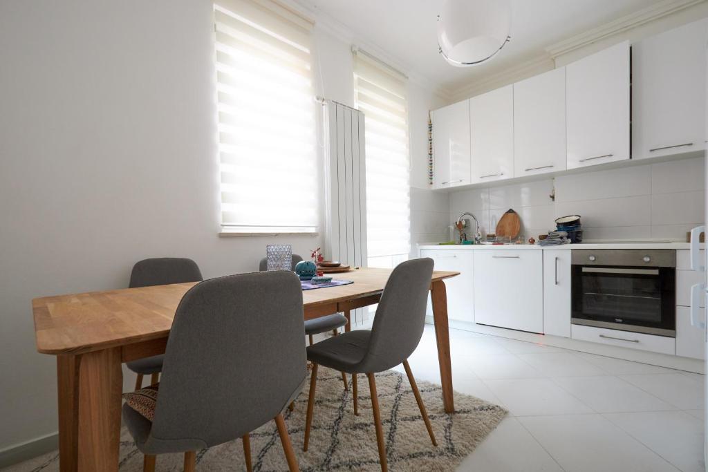 a kitchen with a wooden table and chairs at Old Town Premium Apartment in Sarajevo