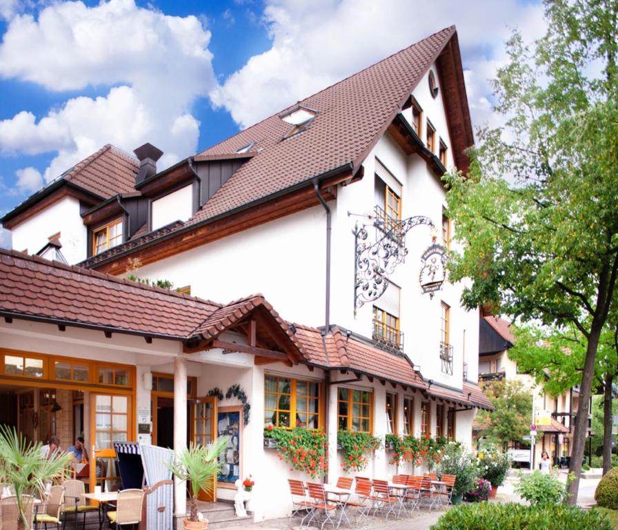 a large white building with a brown roof at Kohlers Hotel Engel in Bühl