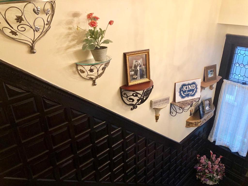 a stairway with a bunch of pictures on the wall at Redwood Bed and Breakfast in Niagara Falls
