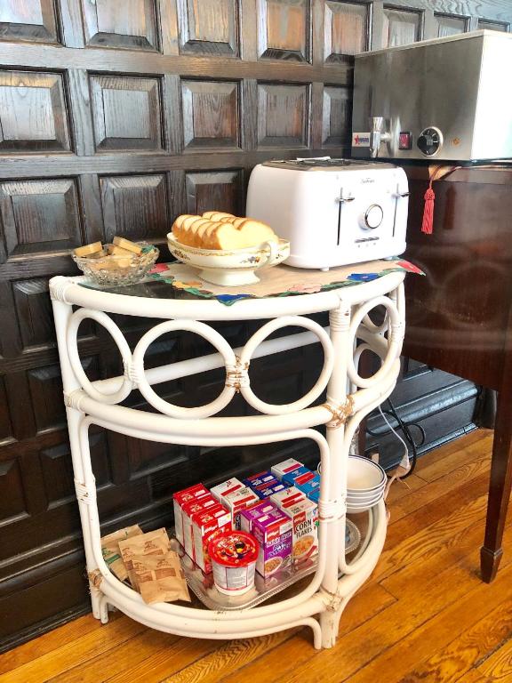 a white stand with food and a toaster on it at Redwood Bed and Breakfast in Niagara Falls