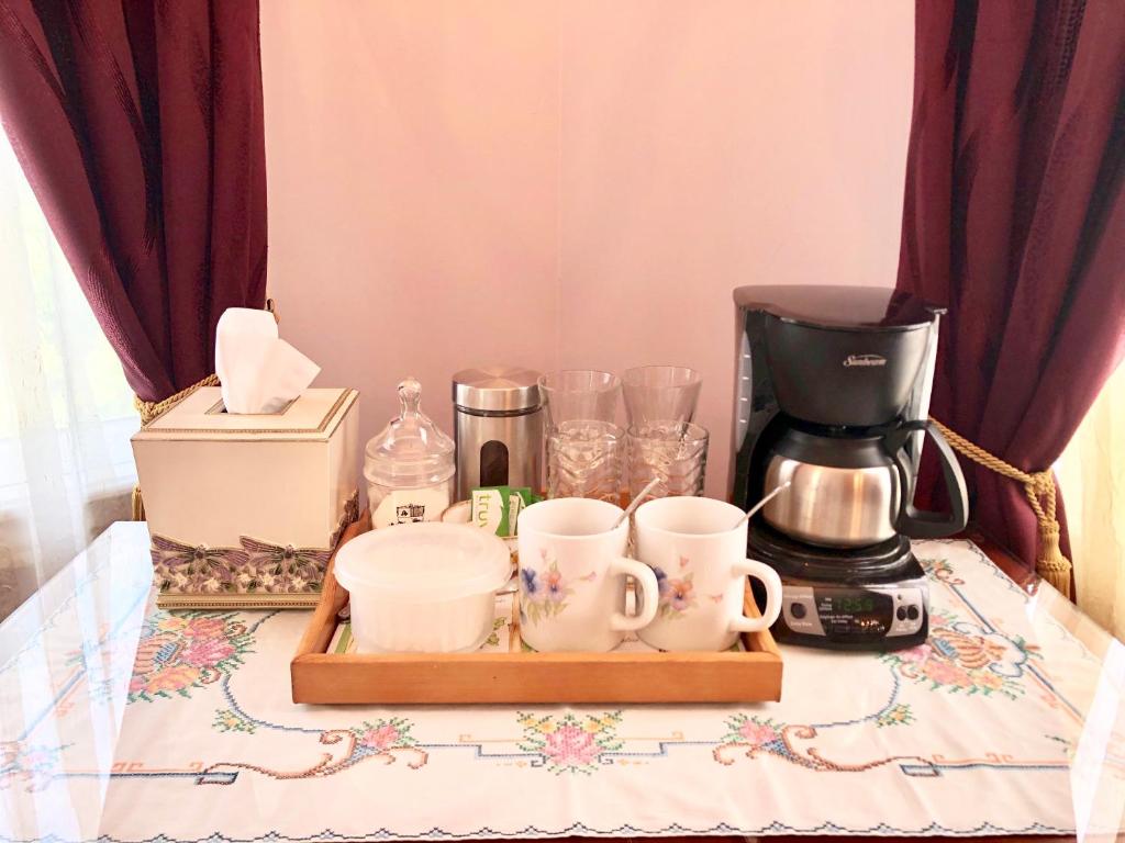 a tray with cups and a coffee maker on a table at Redwood Bed and Breakfast in Niagara Falls