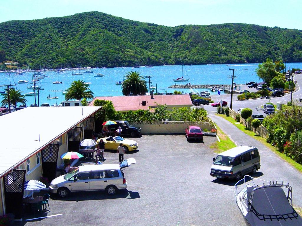 a group of cars parked in a parking lot next to a harbor at Beachside Sunnyvale Motel in Picton