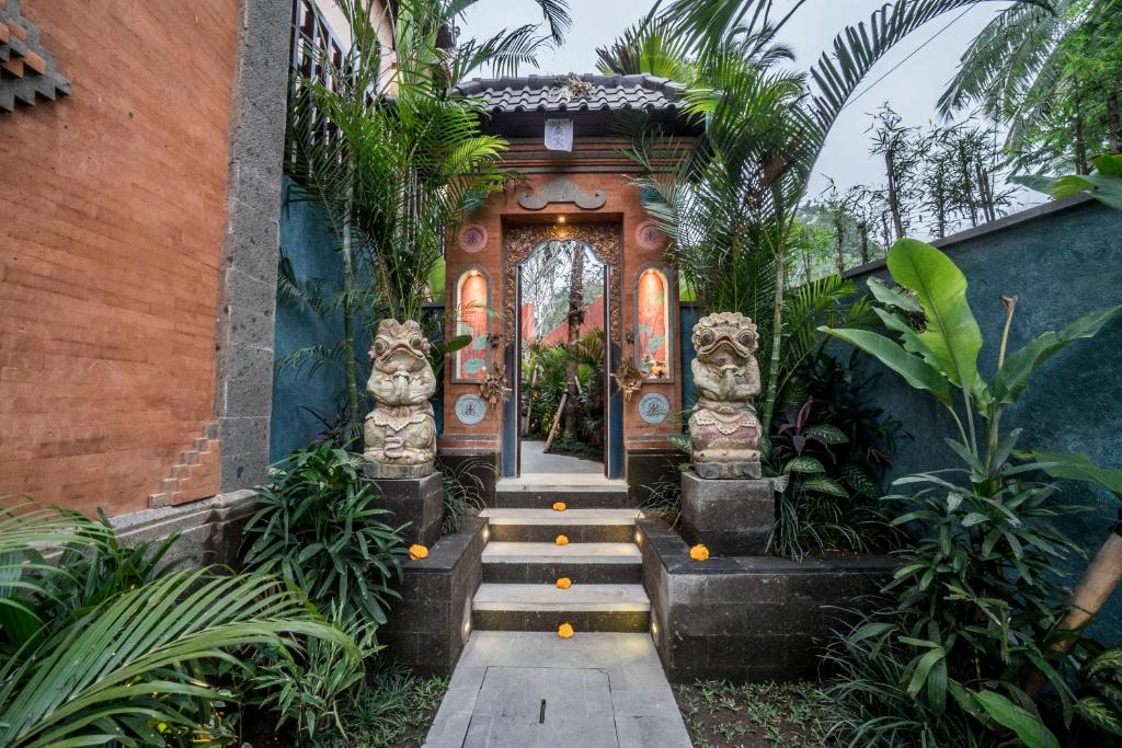 a front door of a house with plants at Villa Tanah Carik by Mahaputra in Tegalalang