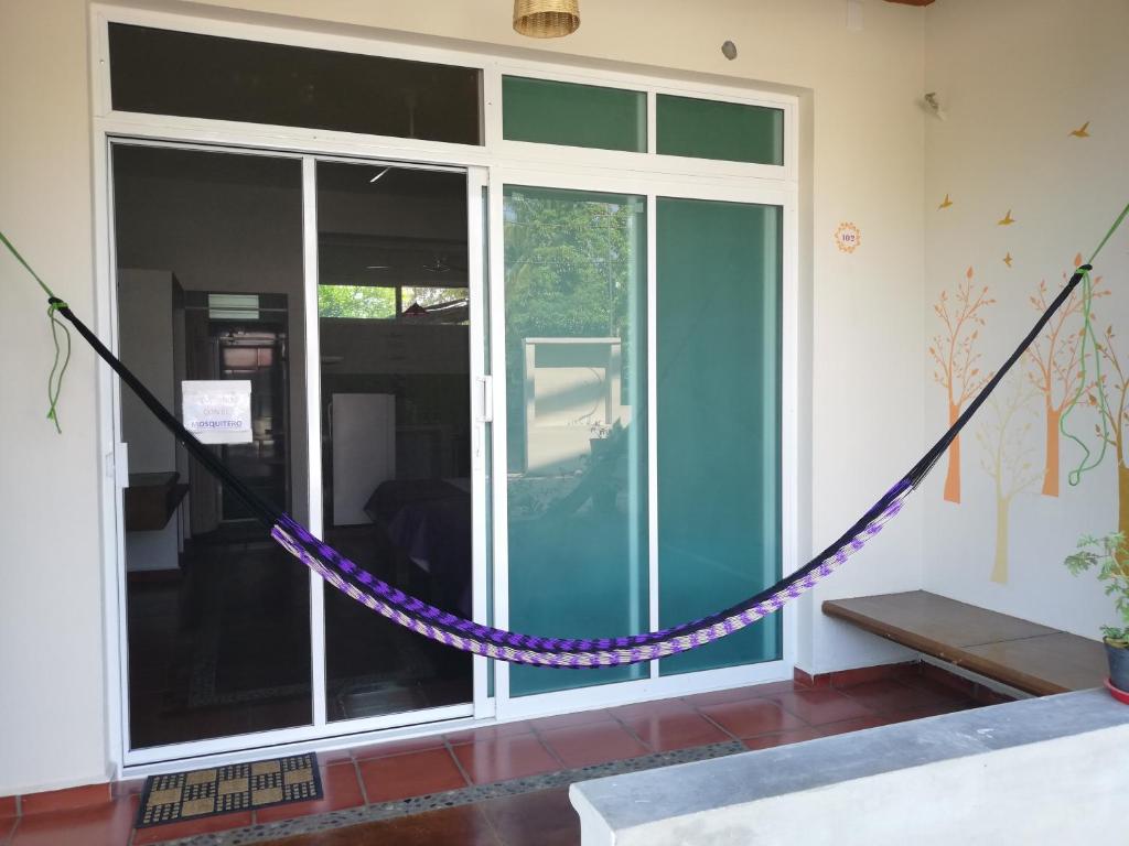 a purple rope tied to a room with a window at Casa Puerto Bonito & Private Coworking in Puerto Escondido
