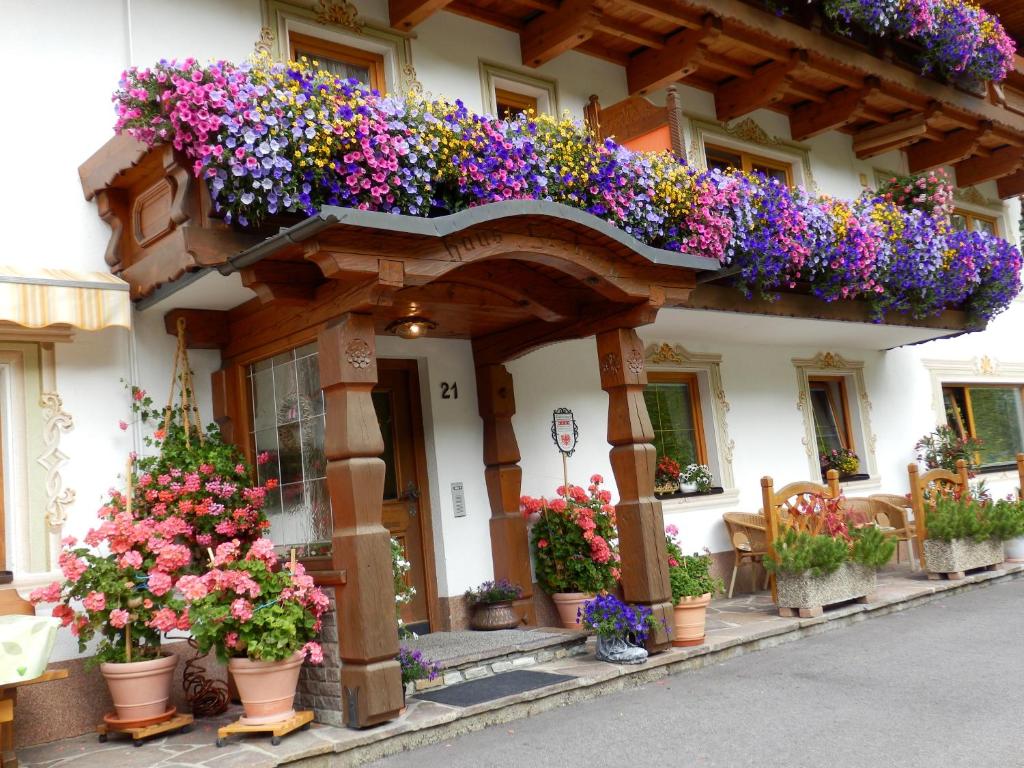 ein Gebäude mit vielen Blumentöpfen darauf in der Unterkunft Haus Seebach in Berwang