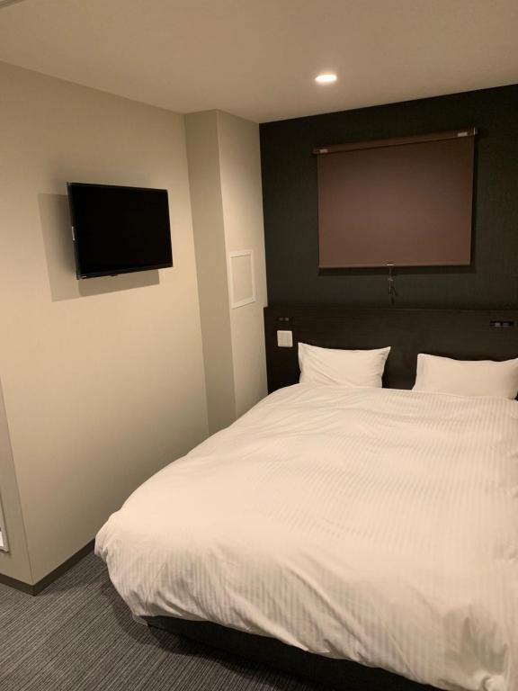 Postel nebo postele na pokoji v ubytování Hotel Kojan