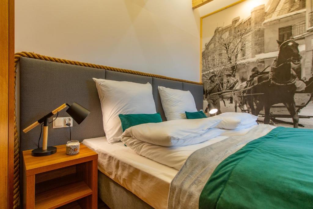 a bedroom with a bed and a lamp on a table at Stacja Zakopane - Apartamenty w centrum in Zakopane