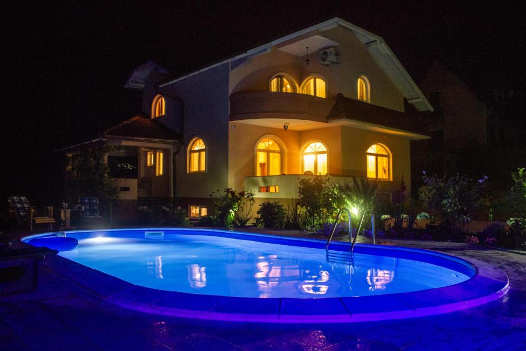 una casa con piscina por la noche en Villa Katarina with pool, en Banja Luka