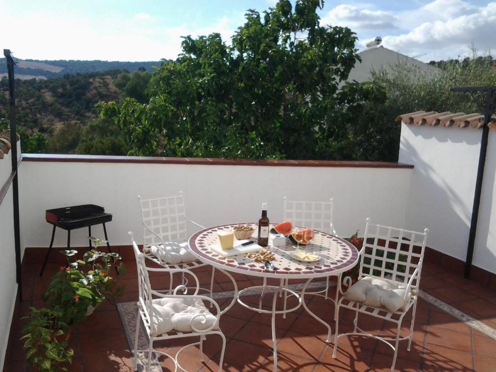 d'une terrasse avec une table et des chaises sur un balcon. dans l'établissement CASA MARIA LUISA, à El Bosque