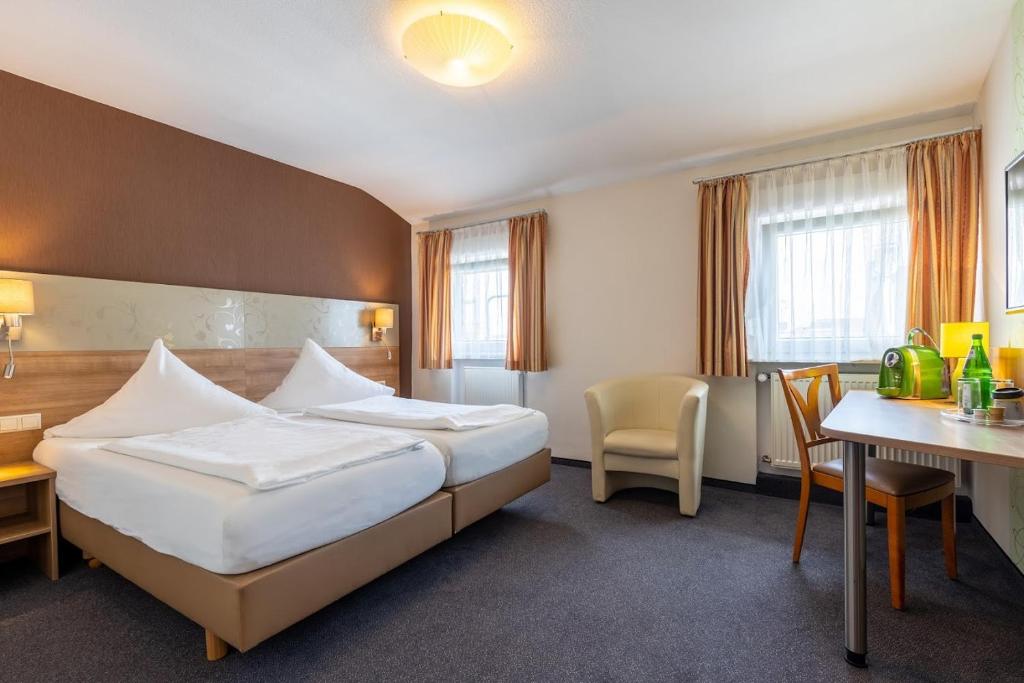 a hotel room with a bed and a table at Trip Inn Hotel Hamm in Koblenz