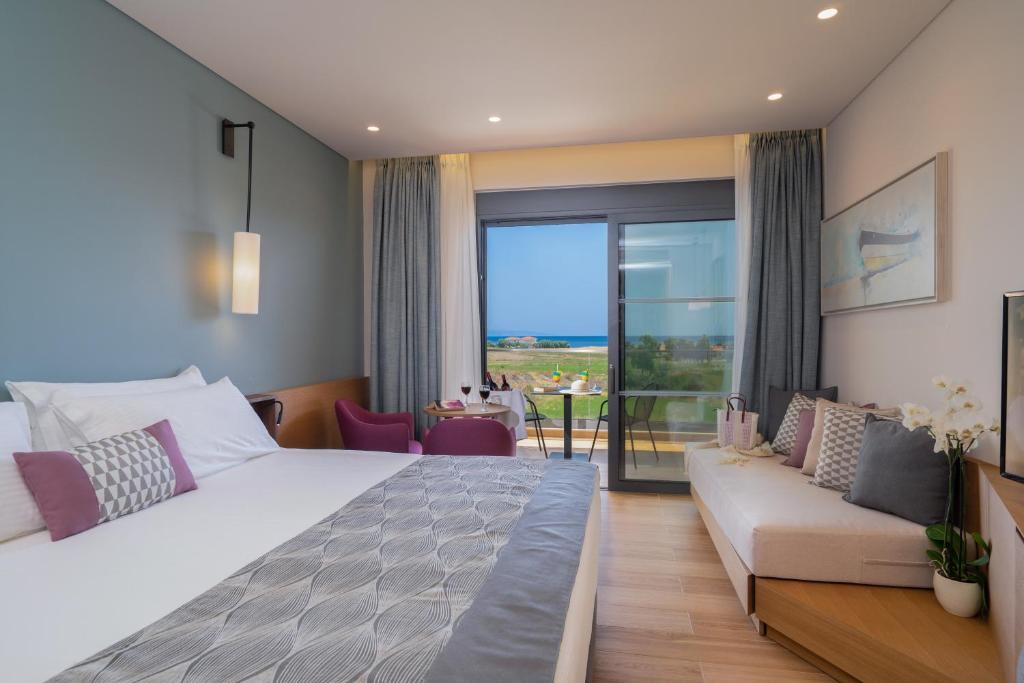 A bed or beds in a room at Apollonion Asterias Resort and Spa