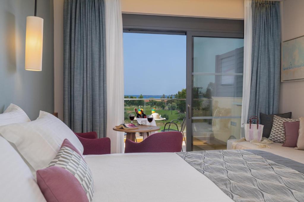 A bed or beds in a room at Apollonion Asterias Resort and Spa