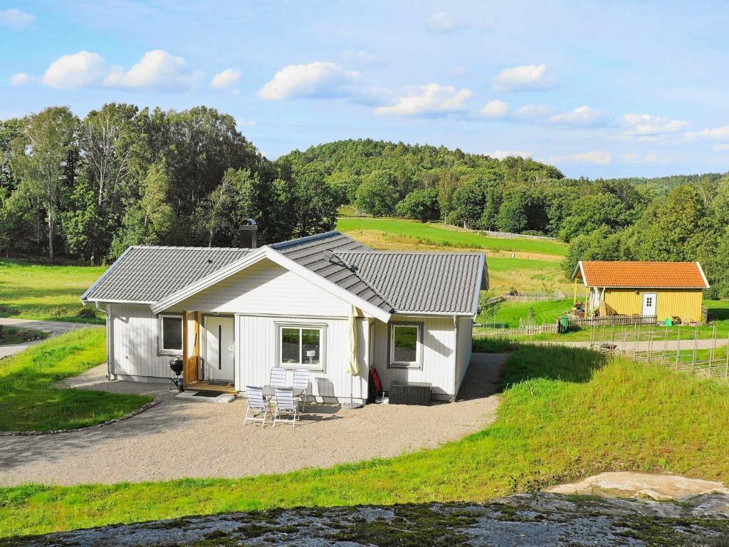 a small white house with a table and chairs at 5 person holiday home in LJUNGSKILE in Ljungskile
