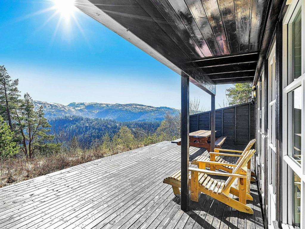 a porch with a bench and a view of the mountains at 10 person holiday home in SERAL in Åseral