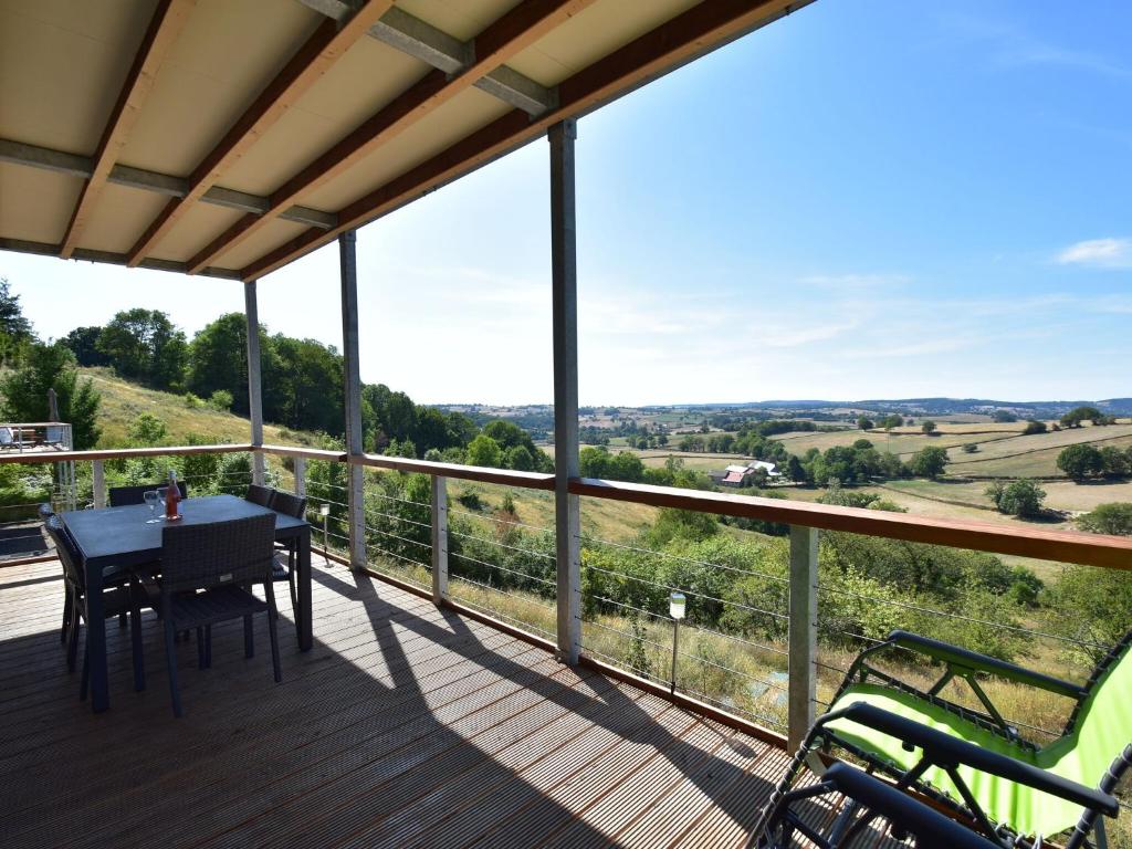 a view from the deck of a house with a table and chairs at Splendid Mansion in Cuzy with Swimming Pool in Cuzy