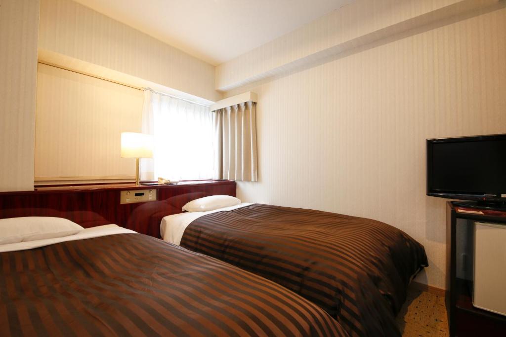 Postel nebo postele na pokoji v ubytování Hotel Sunlife