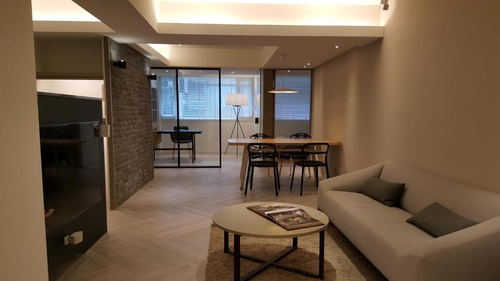 a living room with a couch and a table at 3 Bedrooms and 1 Study and 3 Bathrooms Near Taipei 101 & MRT in Taipei