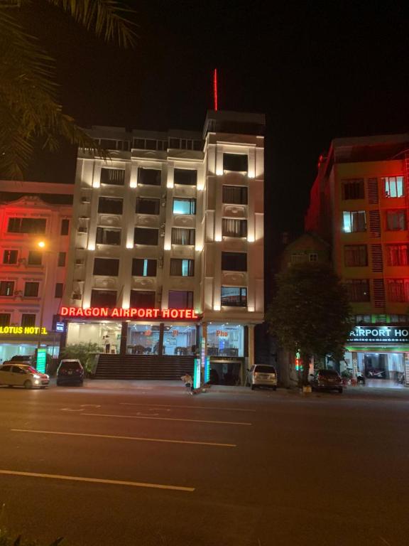 a building with a sign that reads dragon airport house at night at Dragon Airport Hotel in Noi Bai