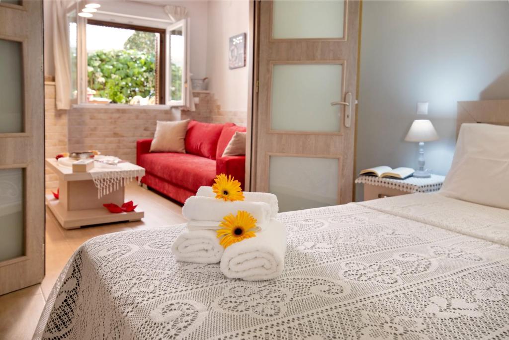 a bedroom with a bed with towels on it at Sweet home apartment in Gaios