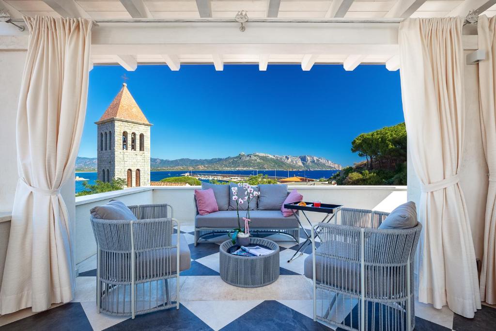 a living room with a view of a building at Raphael Hotel Arbatax in Àrbatax