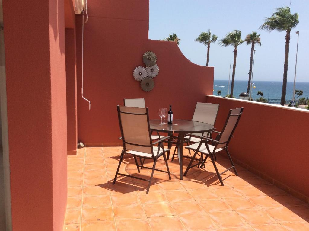 a dining room with a table and chairs and the ocean at Agua Marina exklusiv apartment in Benalmádena