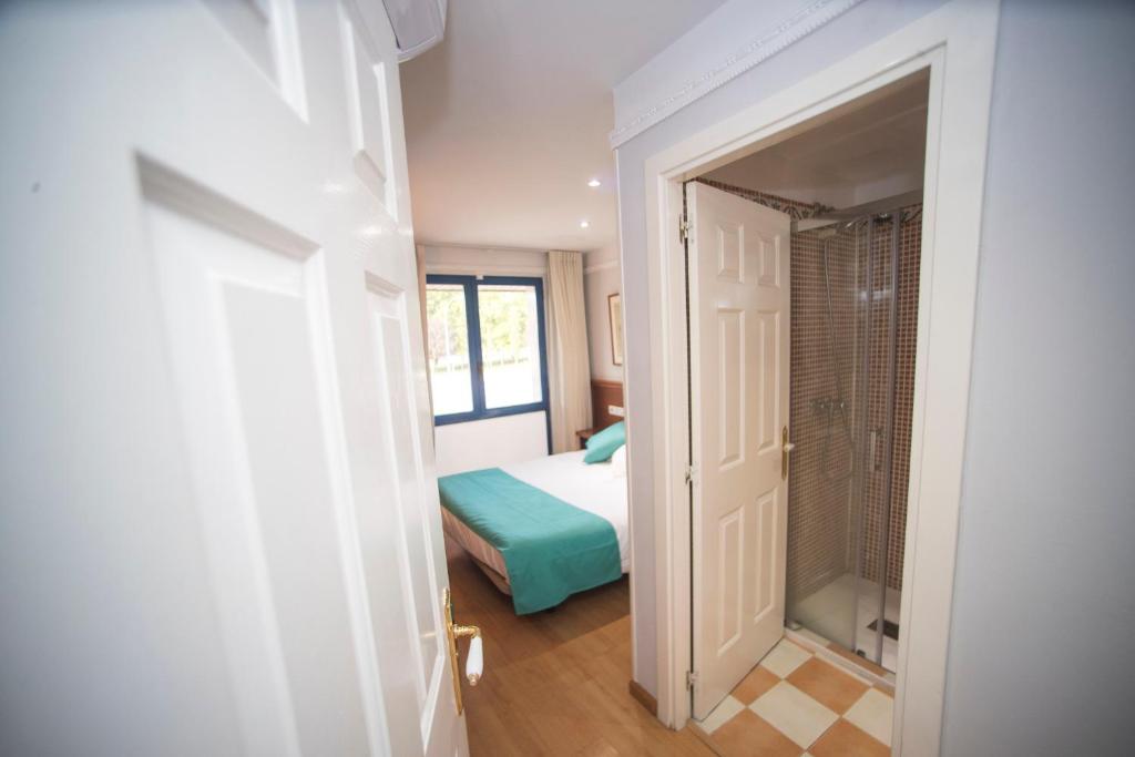 Postel nebo postele na pokoji v ubytování Hotel Alba