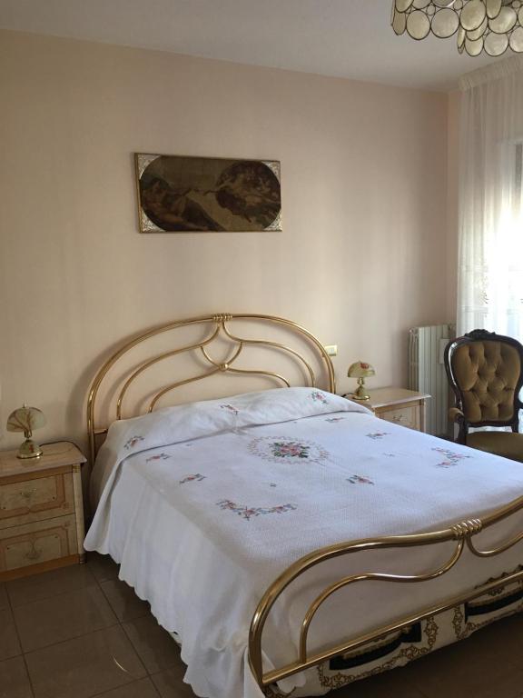 a bedroom with a large bed with a white blanket at La tua casa a Matera in Matera