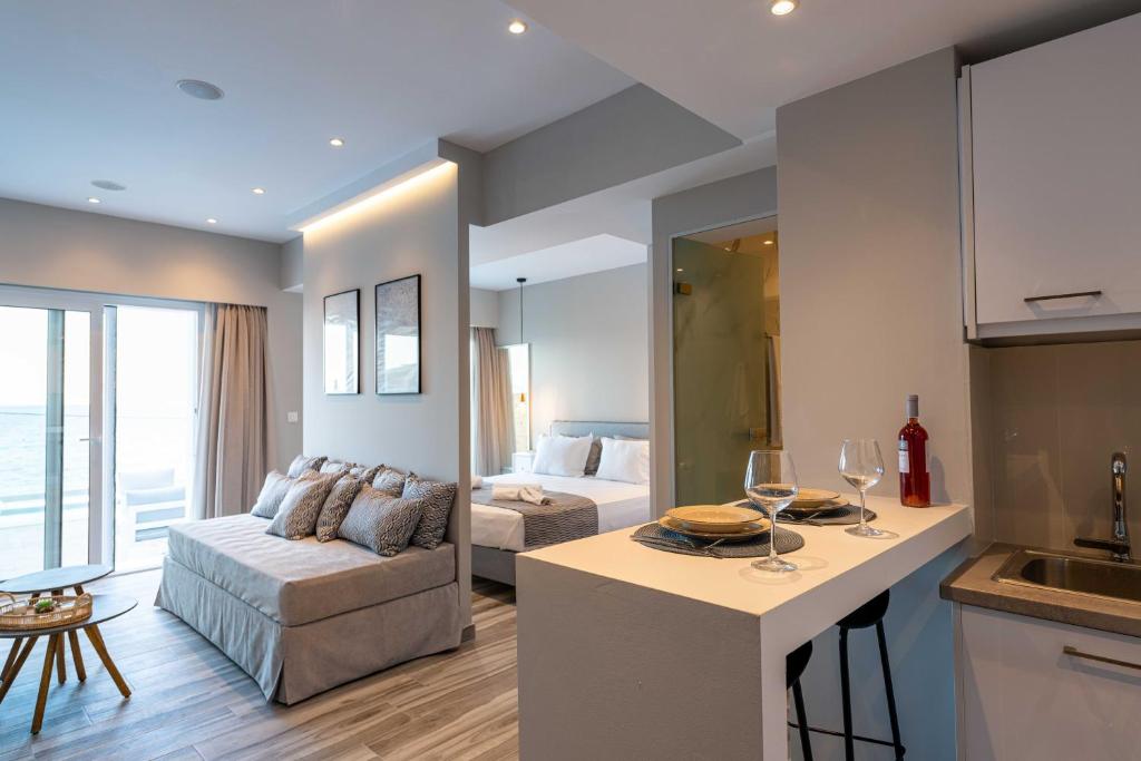a kitchen and living room with a couch and a table at Valtes Luxurious Apartments in Mpoukaris