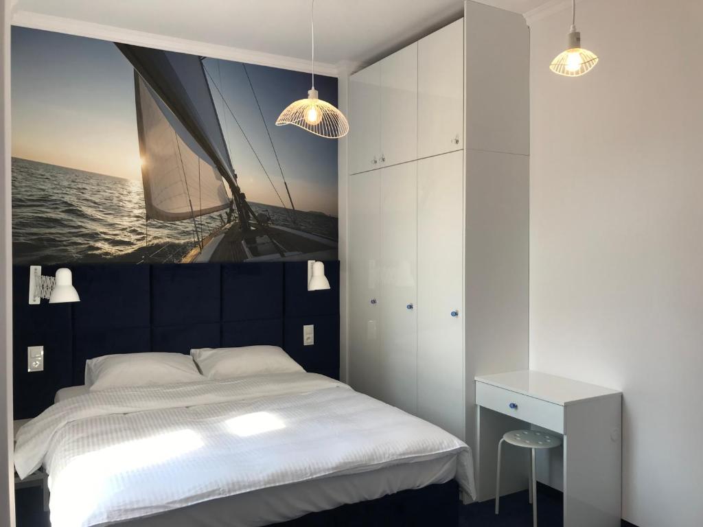 a bedroom with a bed with a sail on the wall at Apartament Pod Żaglami in Gdynia