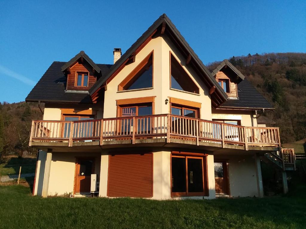 a house with a balcony on the side of it at Heavens Gate in Saint-Pierre-de-Soucy