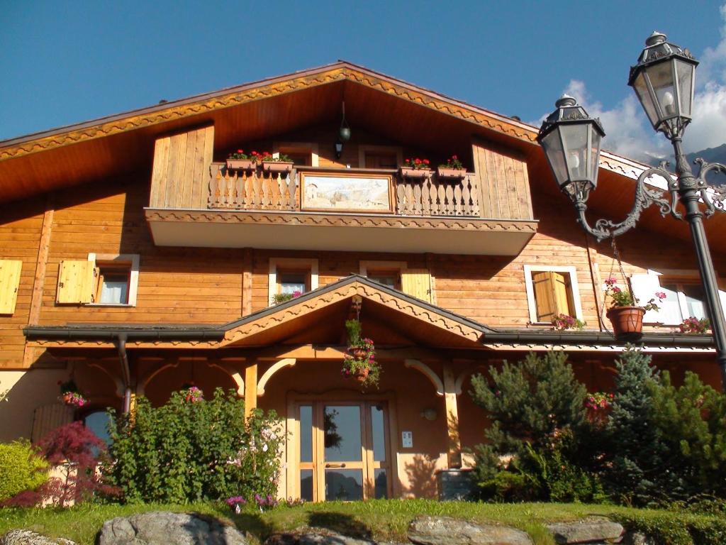 a wooden house with a balcony on top of it at Appartement Les Clarines in Les Houches