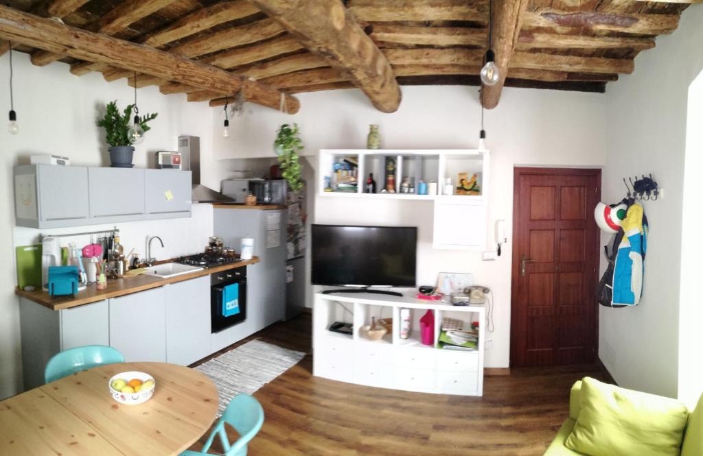 a kitchen with white cabinets and a wooden table at La casa di Gigioz in Sestri Levante
