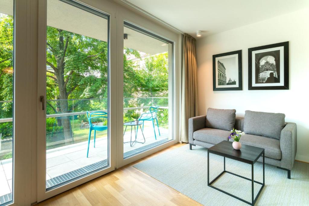 a living room with a sliding glass door at Vienna Residence, Hietzing - Schönbrunn in Vienna