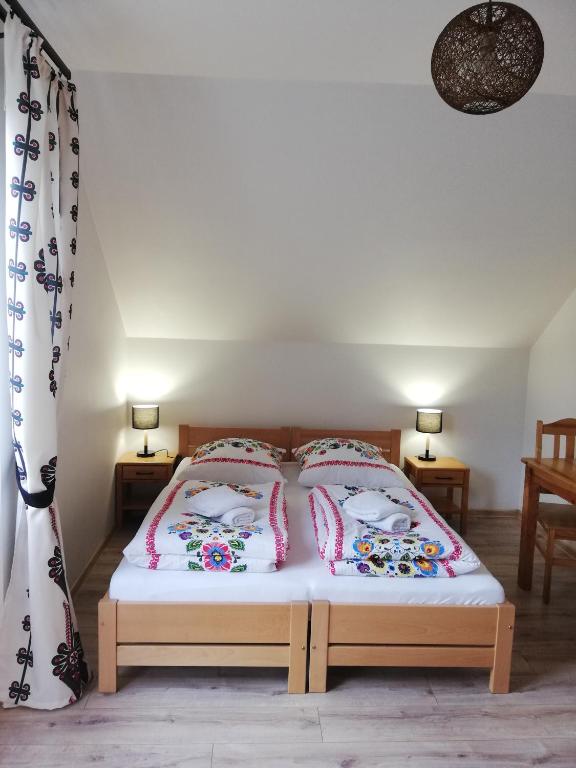 a bedroom with a bed with two pillows on it at Pokoje Czajka- Agroturystyka in Ochotnica Górna