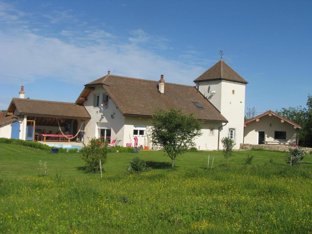 una gran casa blanca en un campo de hierba en Chambre d'hôtes Chez Karine et Roland, en Le Fied