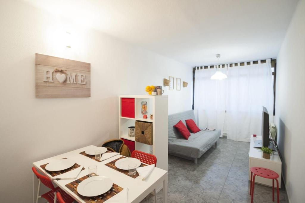 a living room with a table and a couch at Cosy Apartment Fira Barcelona in Barcelona
