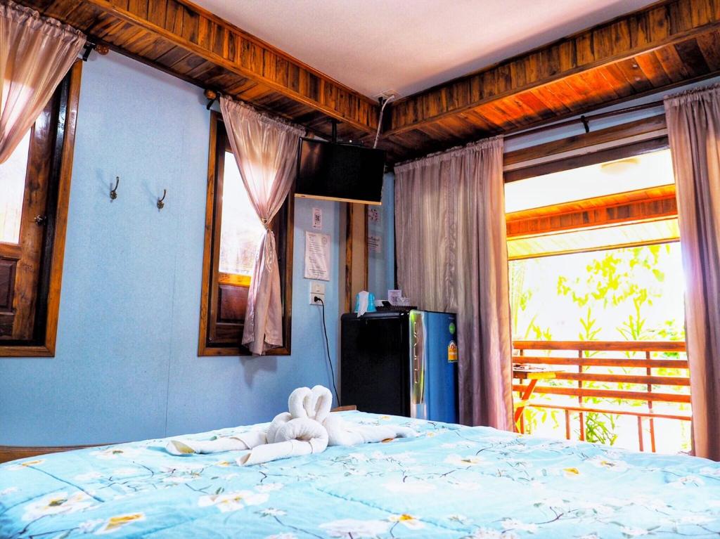 Postel nebo postele na pokoji v ubytování Baansuan Resort