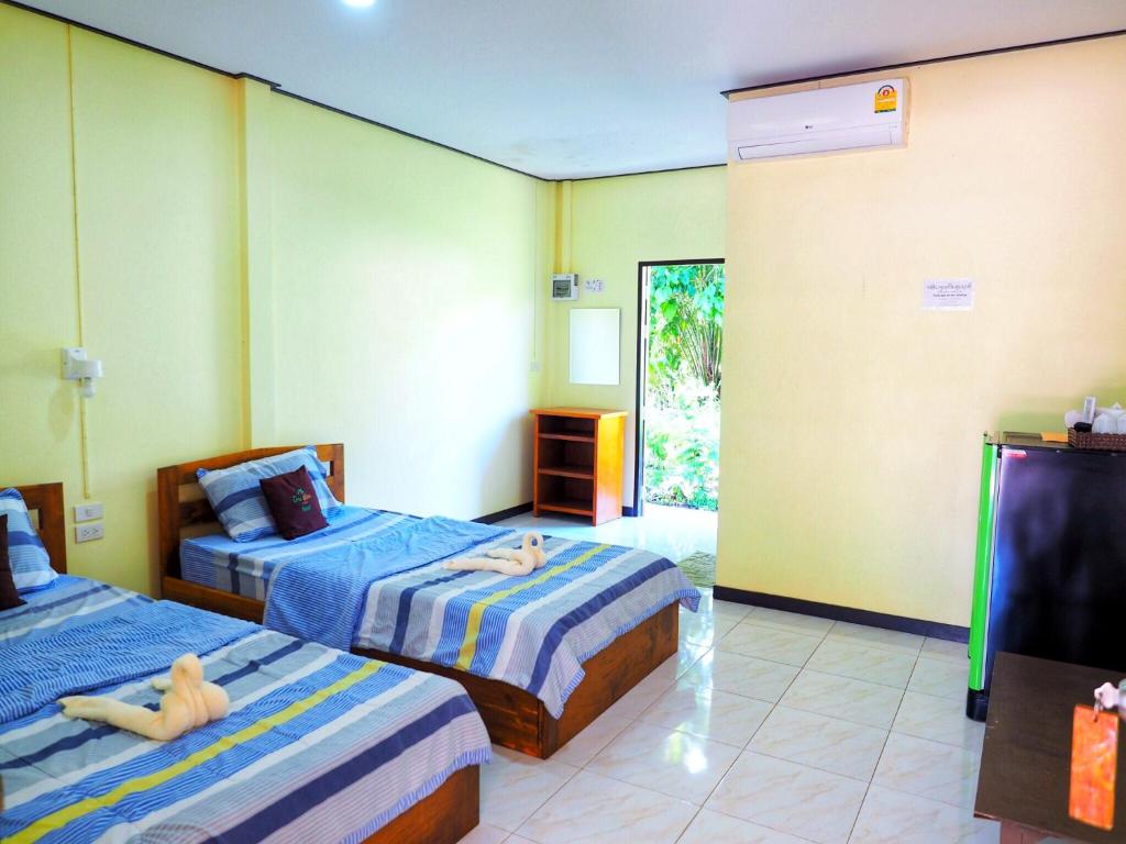 Postel nebo postele na pokoji v ubytování Baansuan Resort