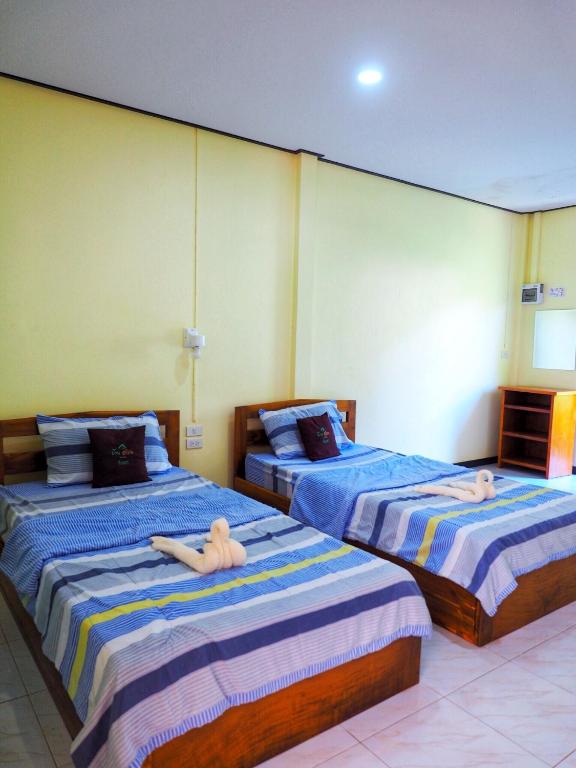 Postel nebo postele na pokoji v ubytování Baansuan Resort